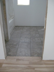 Tile laid in upstairs hall bath