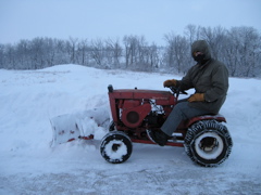 John on the Wheel Horse, moving snow.